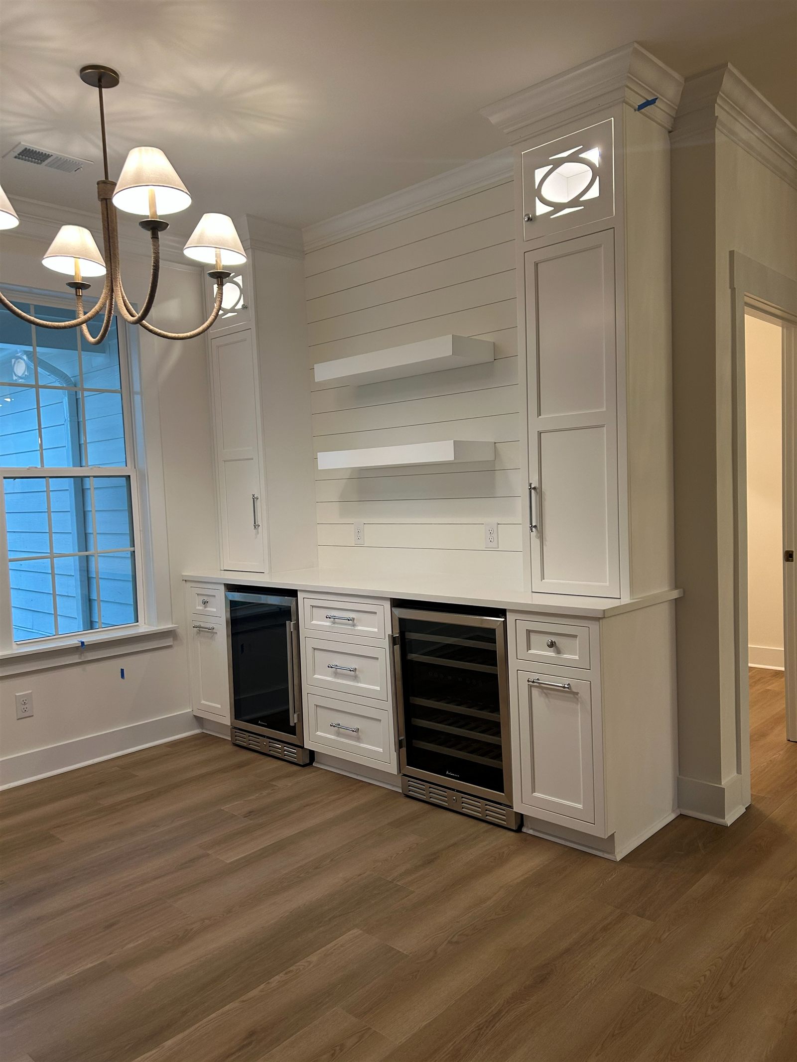 Quartz countertop over built-in wine and beverage fridges