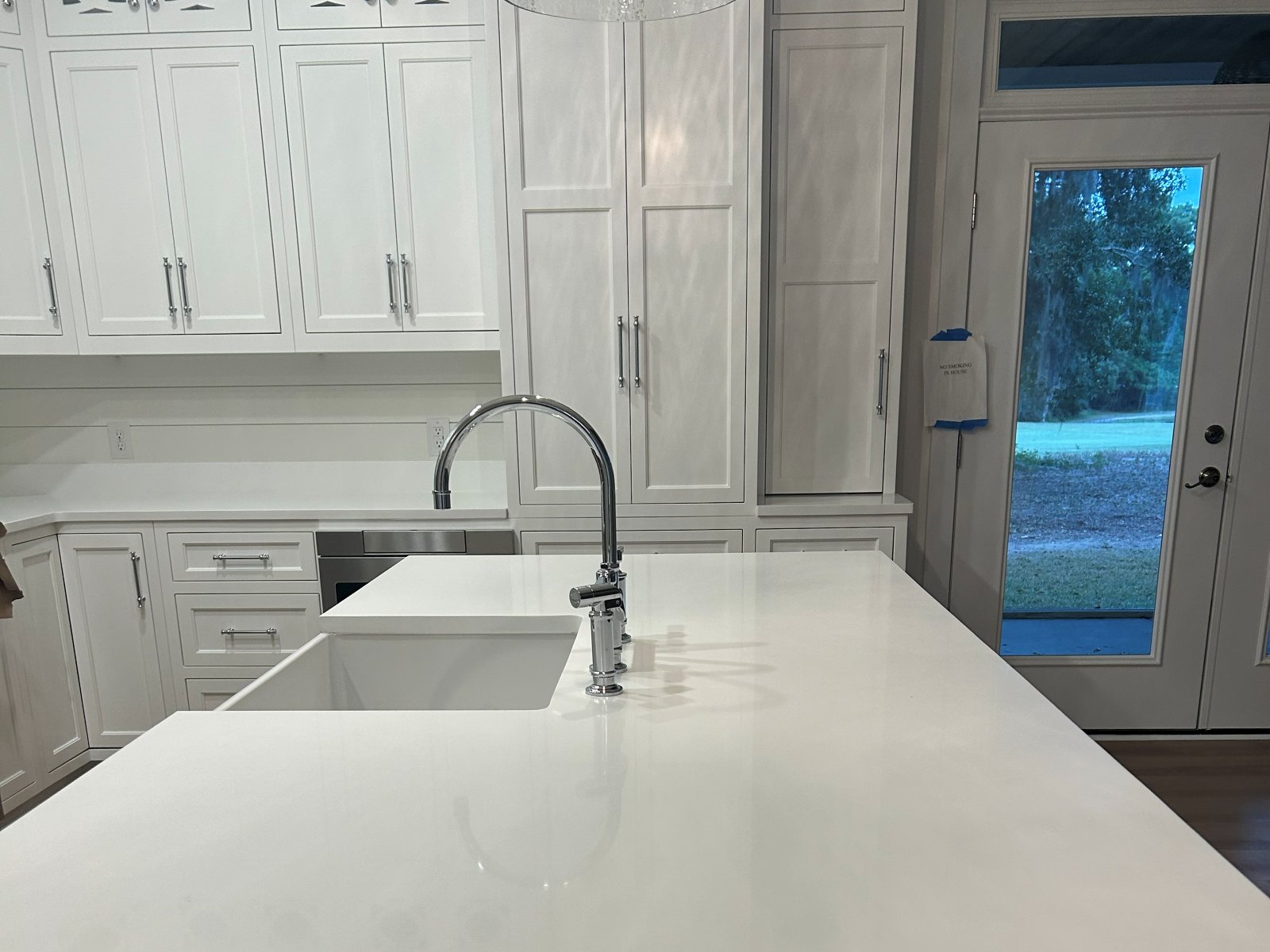 White kitchen cabinets and island installed by Genis Pacific in Shallotte, NC