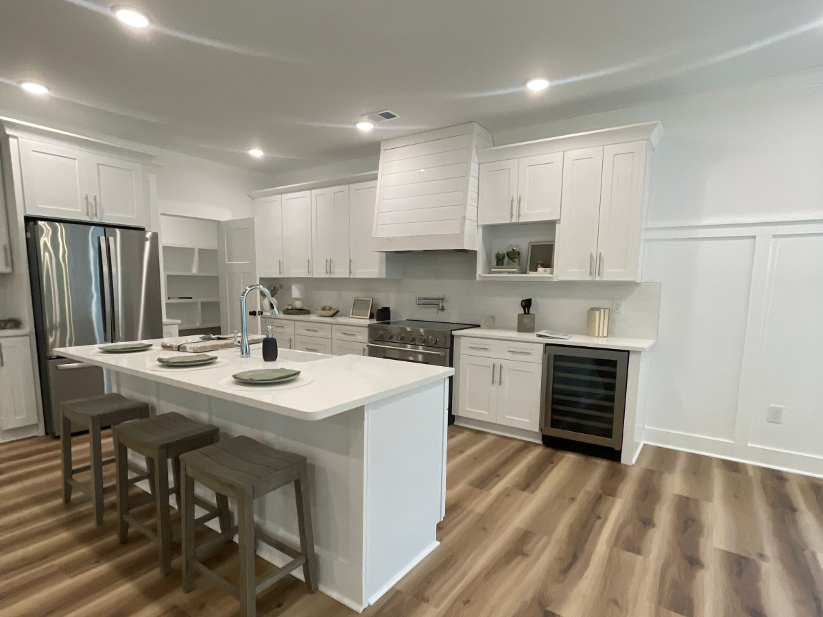 White shaker kitchen with quartz island installed by Genis Pacific in Shallotte, NC